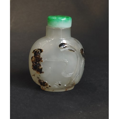 Very well hollowed agate snuff bottle carved in a brown vein from a fisherman at the edge of the water with duck and frog near lotus and millet - on the reverse Zhang Qian on a tree trunk forming a boat -
China official school 1750/1850